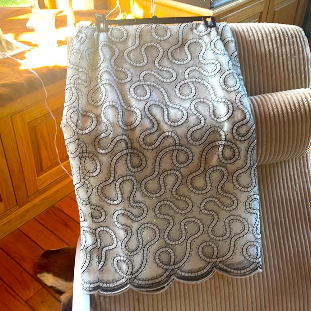 Fancy New white skirt with large lining that is sequined